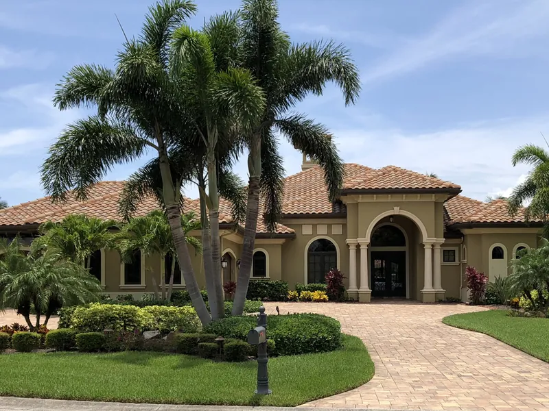 Florida-friendly palms and shrubs framing a home entrance