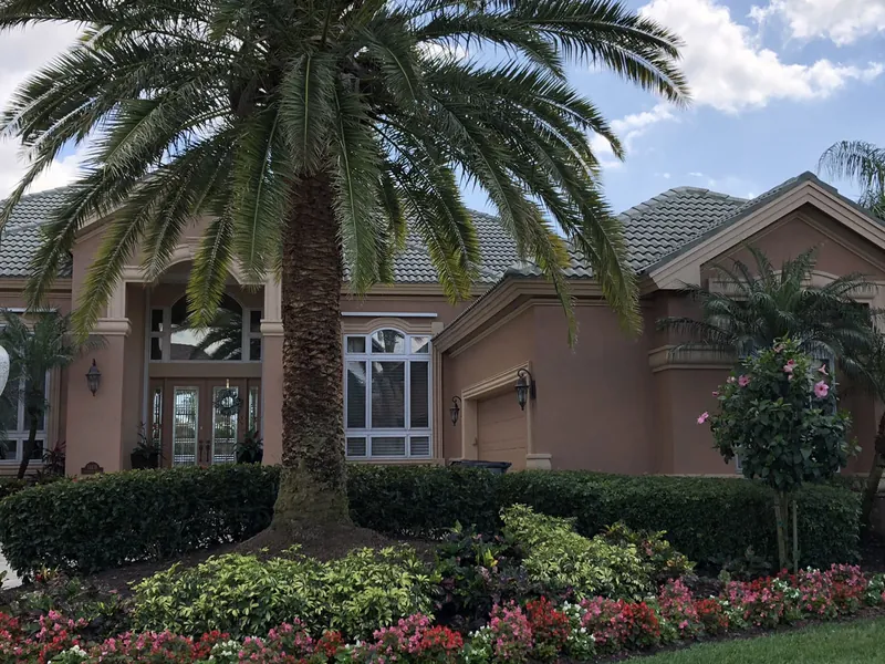 Tropical palms and colorful planting beds in a Florida yard
